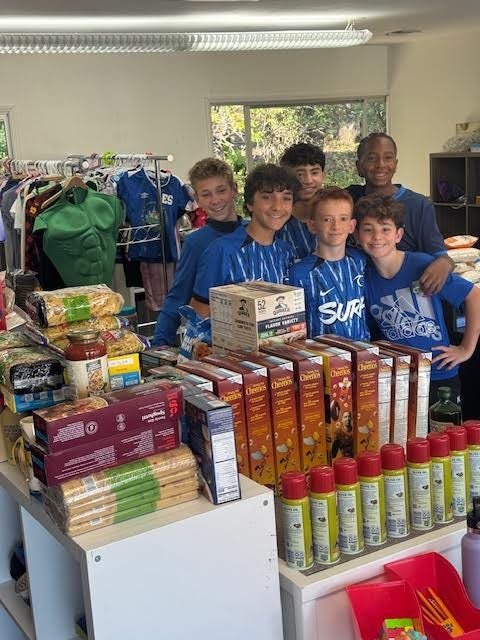 Young volunteers with donated food items at the Lamorinda Care Collective